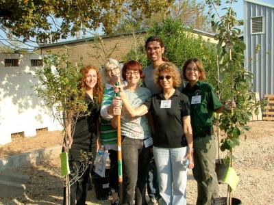 6 people in a group with potted trees, the program managers of ACT.