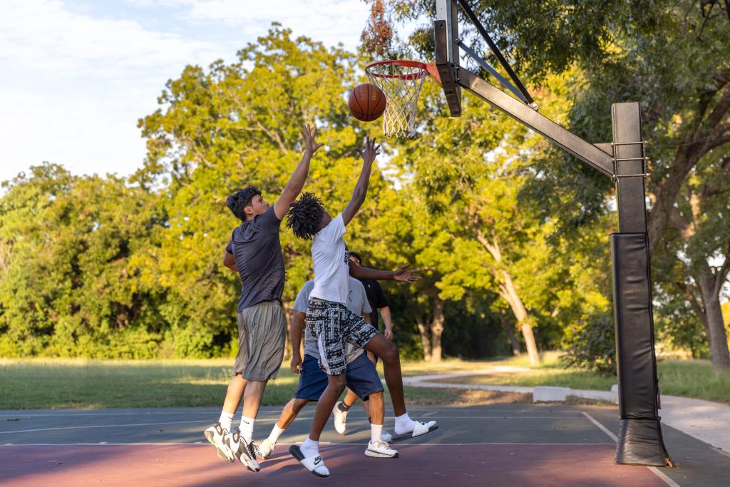 Four people play basketball at Govalle Neighborhood Park