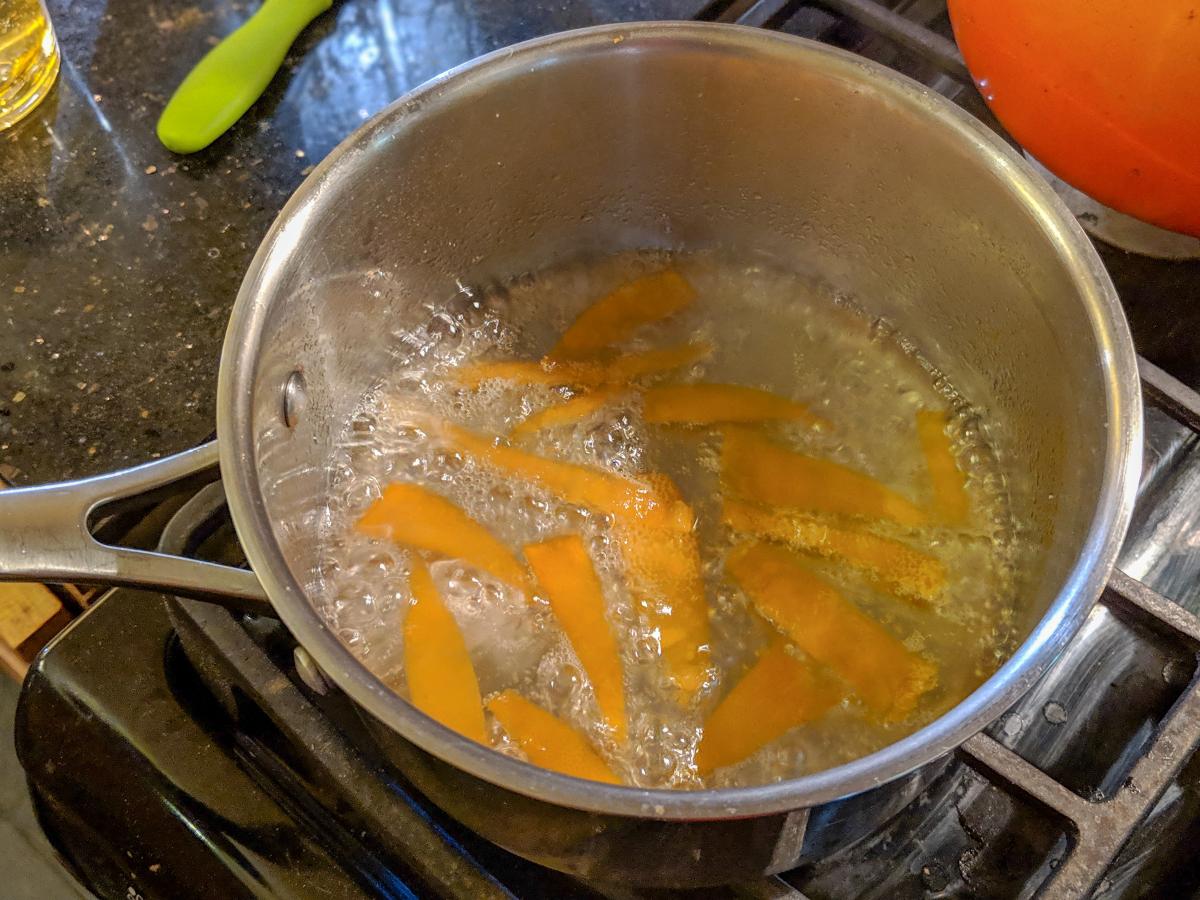 Citrus peels boiling in a pot on the stove.