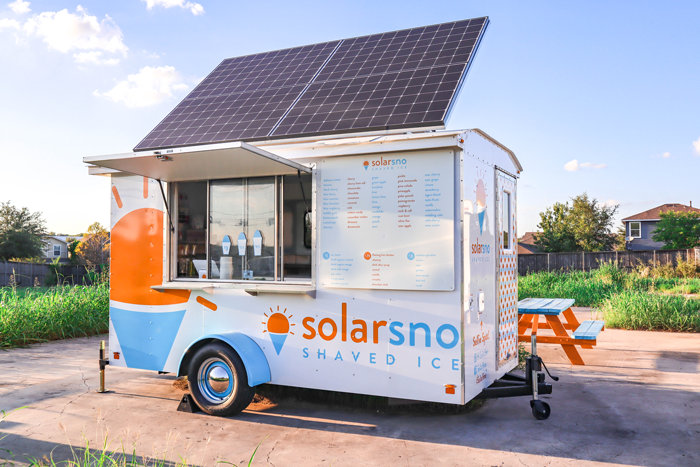 Solar sno food truck with large solar panel on top.