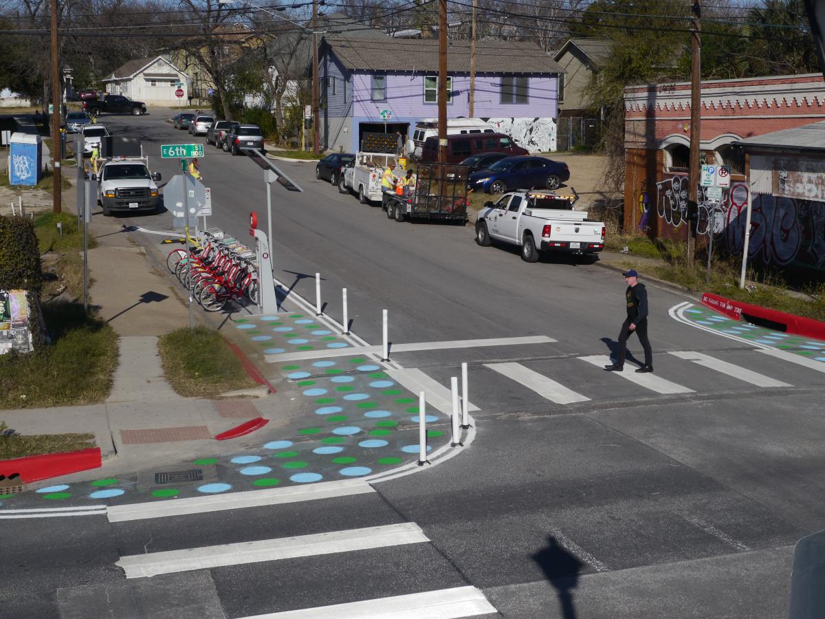 A pedestrian using a crosswalk at Waller and Sixth streets.