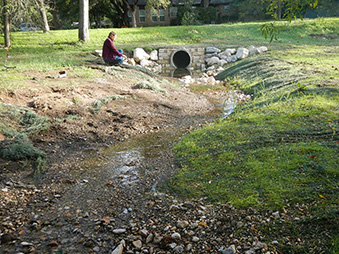 Figure 2b. same location as above, shortly after construction. A sections of the pipe has been removed and replaced by a winding swale.