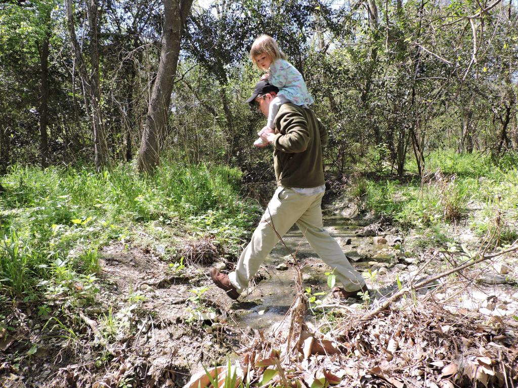 Dad and daughter hopping Central Williamson Creek