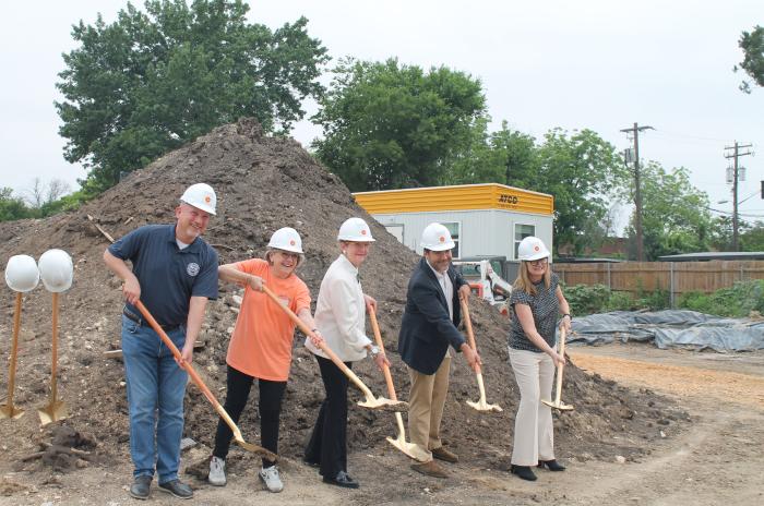 Image shows five people holding dirt-filled shovels at the groundbreaking ceremony for the new community called Cairn Point Cameron groundbreaking ceremony.
