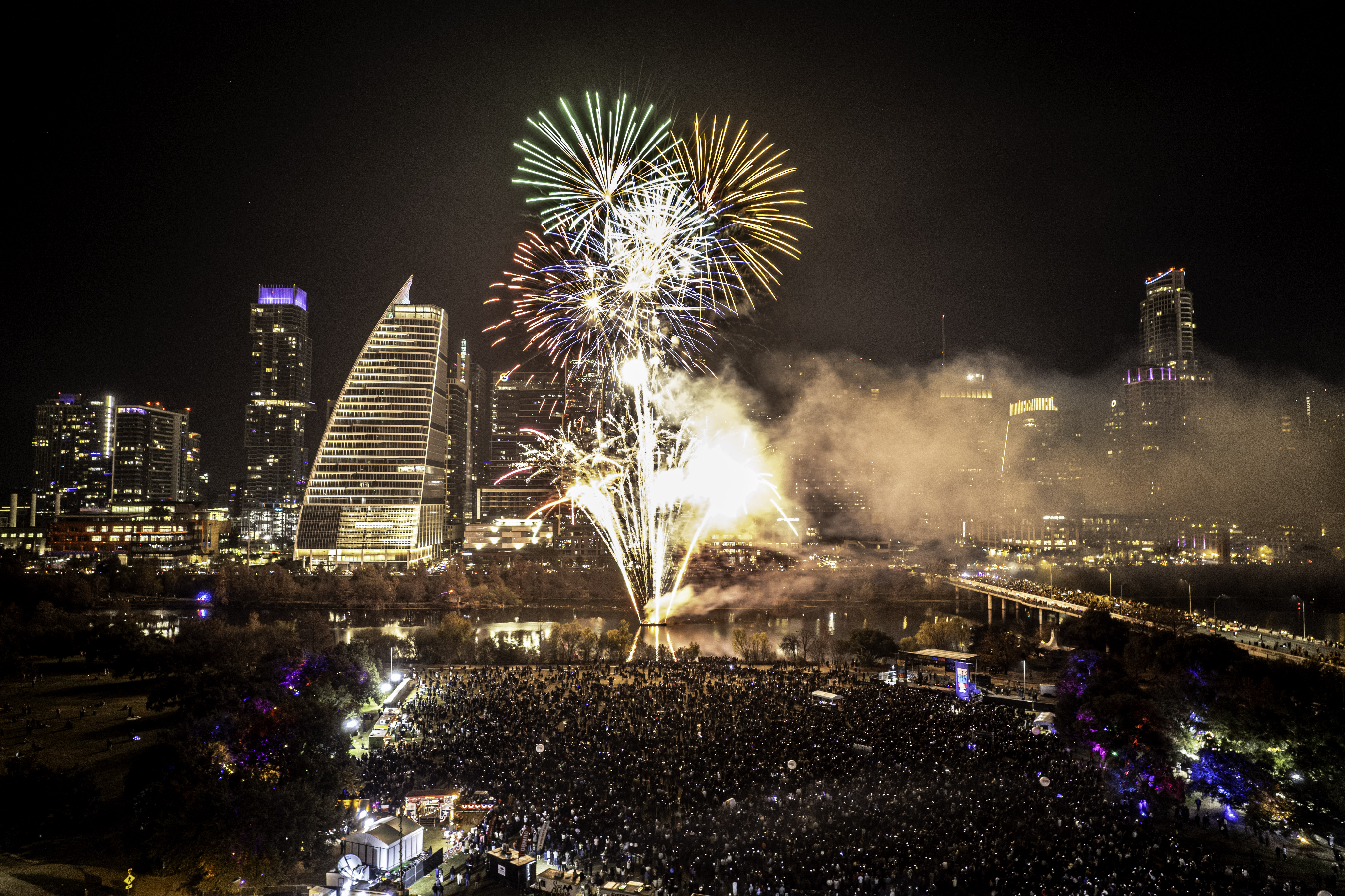 Audtorium Shores at night with downtown Austin lights and fireworks