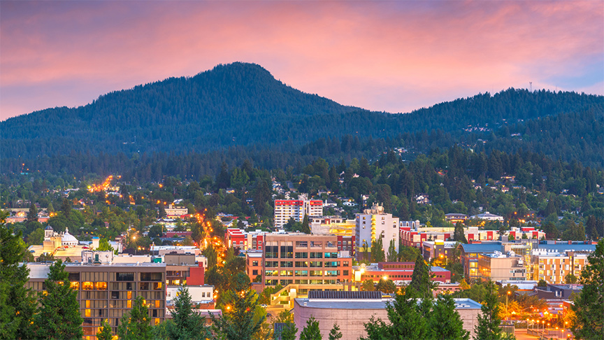 View of Eugene Oregon City in front of mountain range.