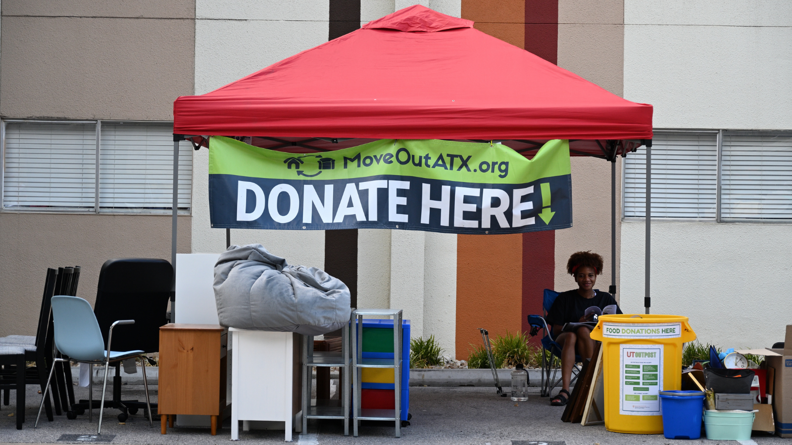 Donation items sit at a MoveOutATX donation station.