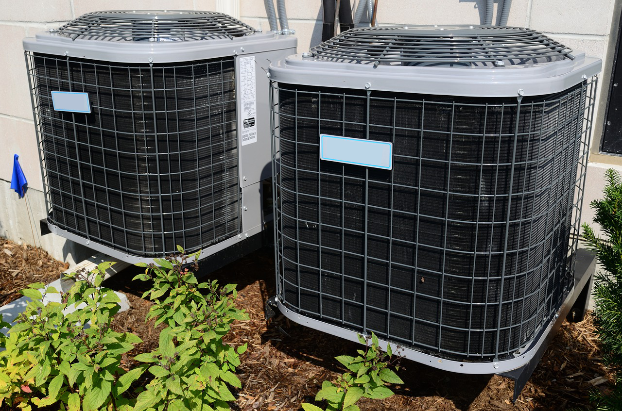 two airconditioning units outside of a residential home