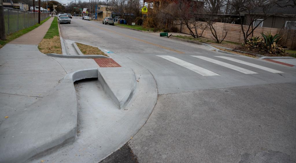 Curb extensions and a raised crossing at an intersection near a school. The curb ramps have space underneath to allow for proper drainage