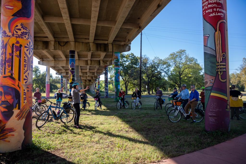 People gathering alongside an urban trail.