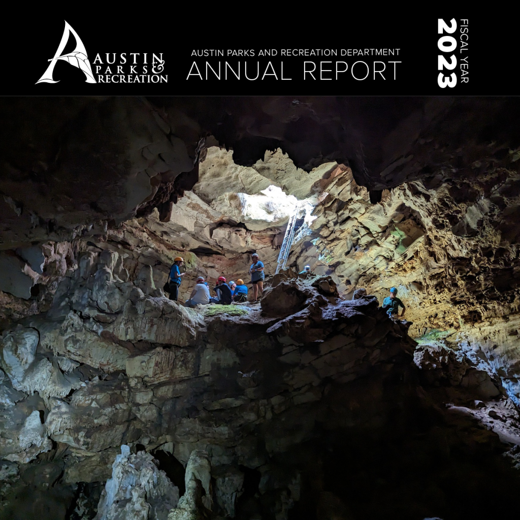 Front cover of FY23 Annual Report - Cave tour with light coming in from above.