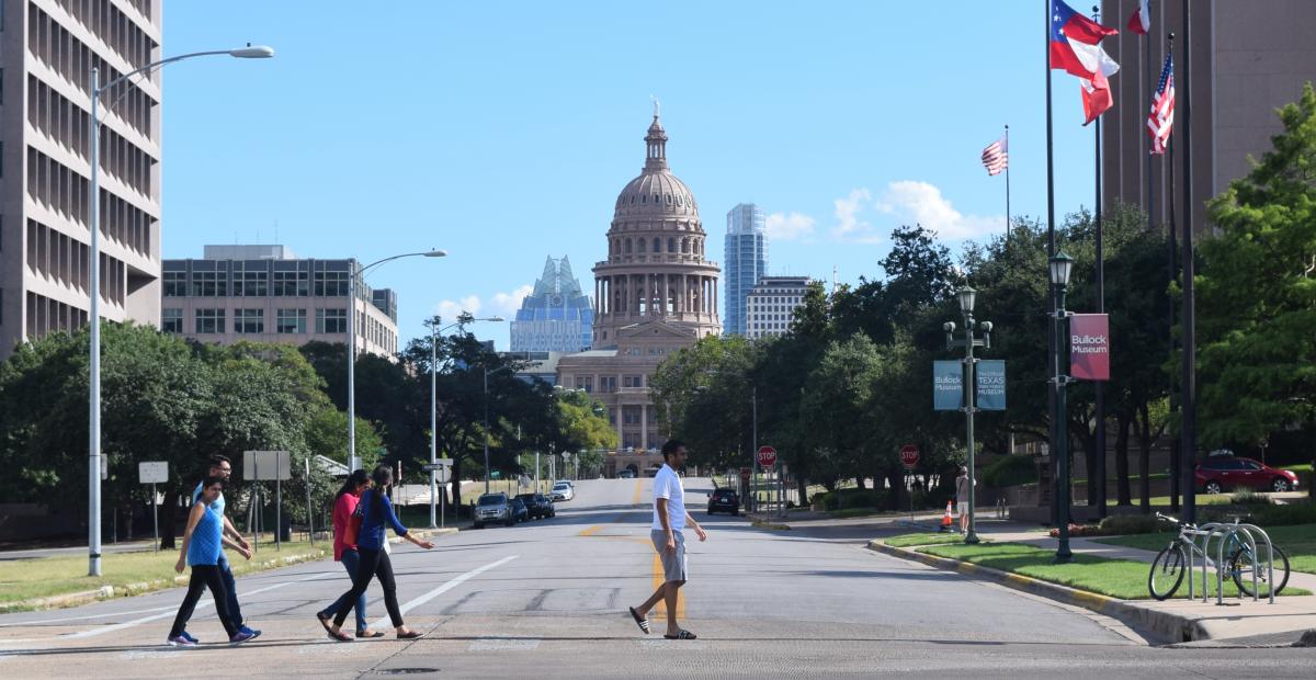 People walking in front of the Texas State Capitol building