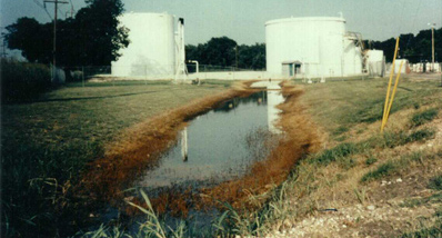 Gasoline spill from above ground storage tanks at a tank farm.