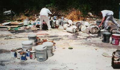 Illegal dumping of paint containers.