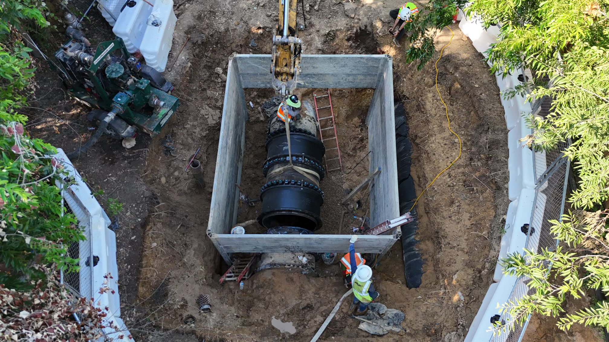 Overhead shot of new large pipe replacement being put in place