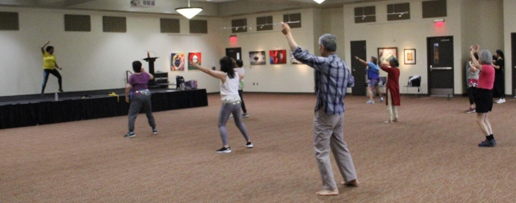 senior program participants exercise in the ballroom for a group wellness class