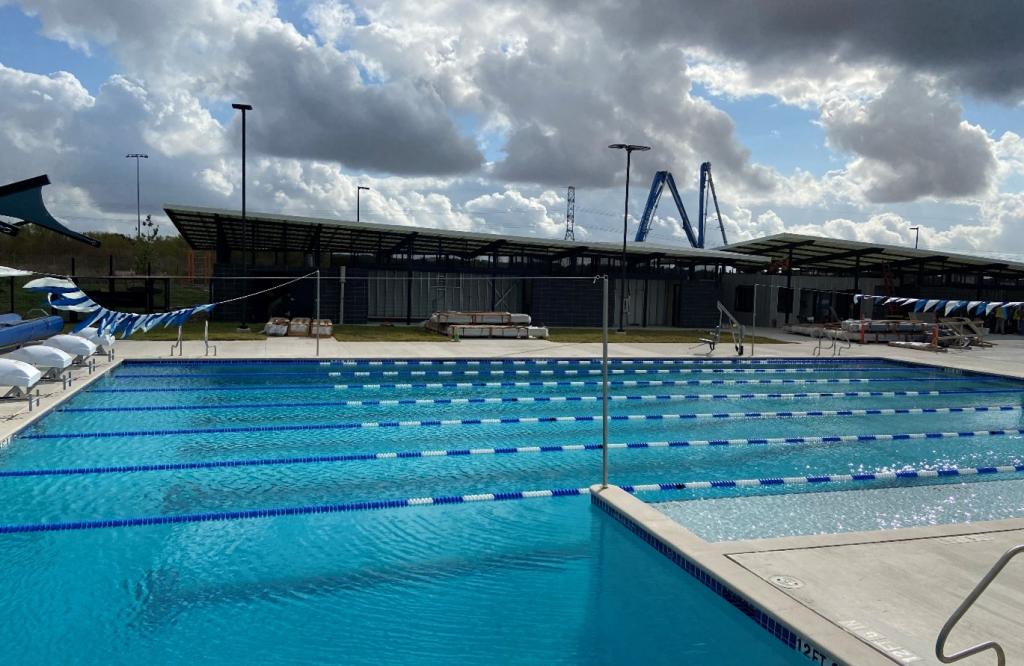 New Colony Park pool view of lap swimming area with bathhouse in background