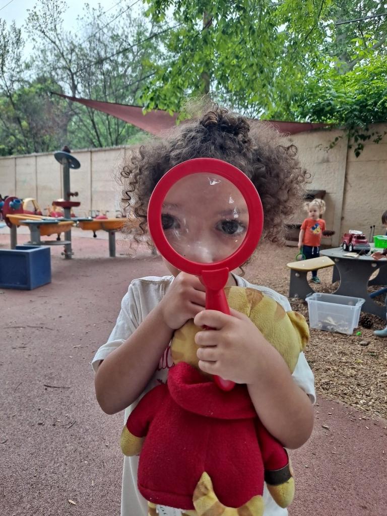 Child holding a magnifying glass