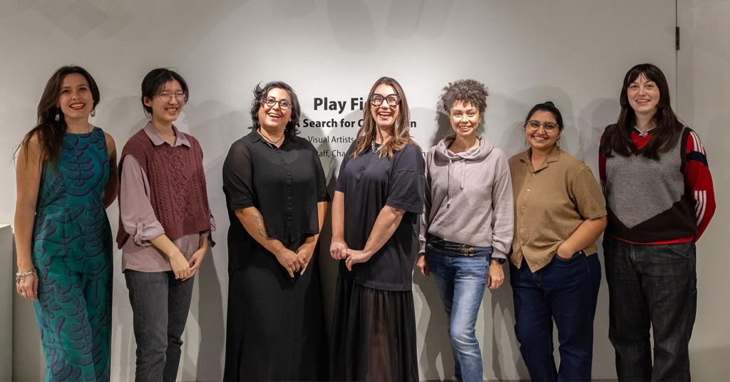 A photograph of seven smiling people, six of which are Dougherty Arts Center Visual Artist In Residence 