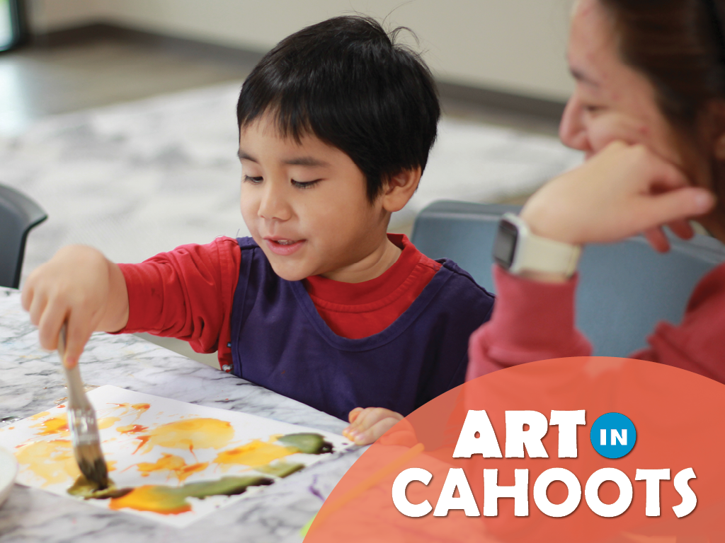 An image of a child painting while an adult looks on and the text 'Art In Cahoots'