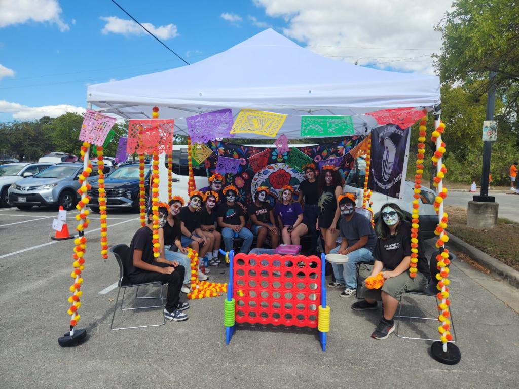Caminos class of 2026 face painting activity for Trunk or Treat event, October 18, 2025