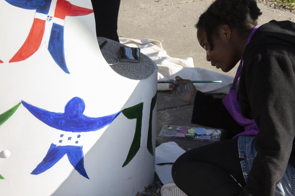 a student painting on a bench