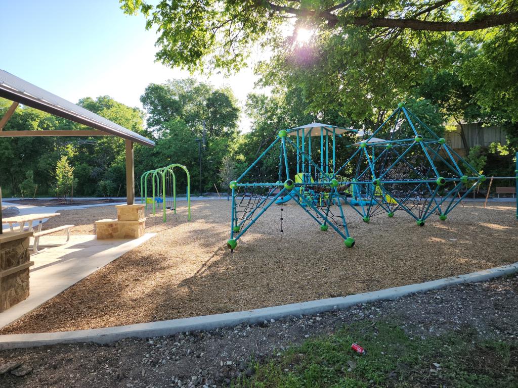 Brownie Park playground with rope climbers and swings and edge of picnic pavilion