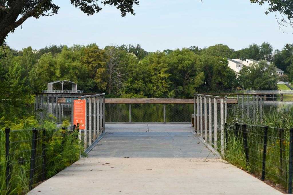 Fishing pier looking toward river with trees in the background