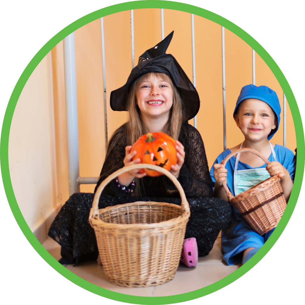 Two kids wear costumes holding large woven baskets.