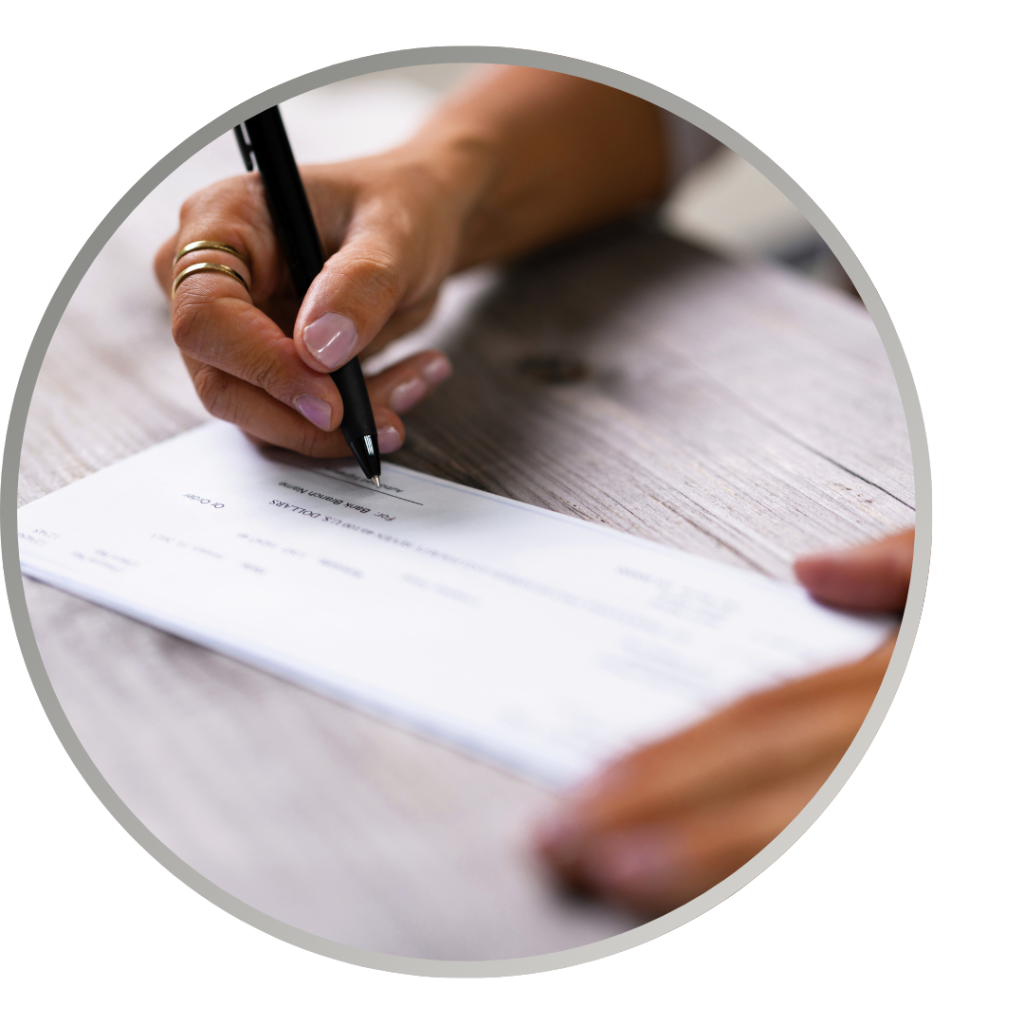 A close up on hands writing a check.