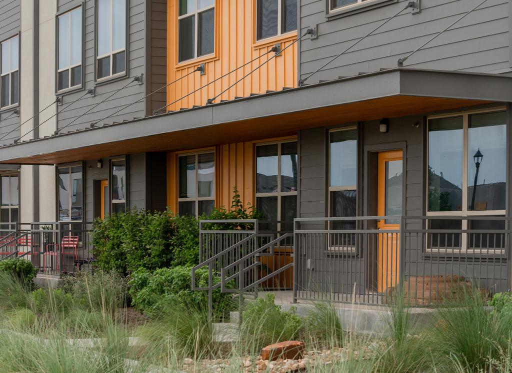 Modern gray building with orange accents.