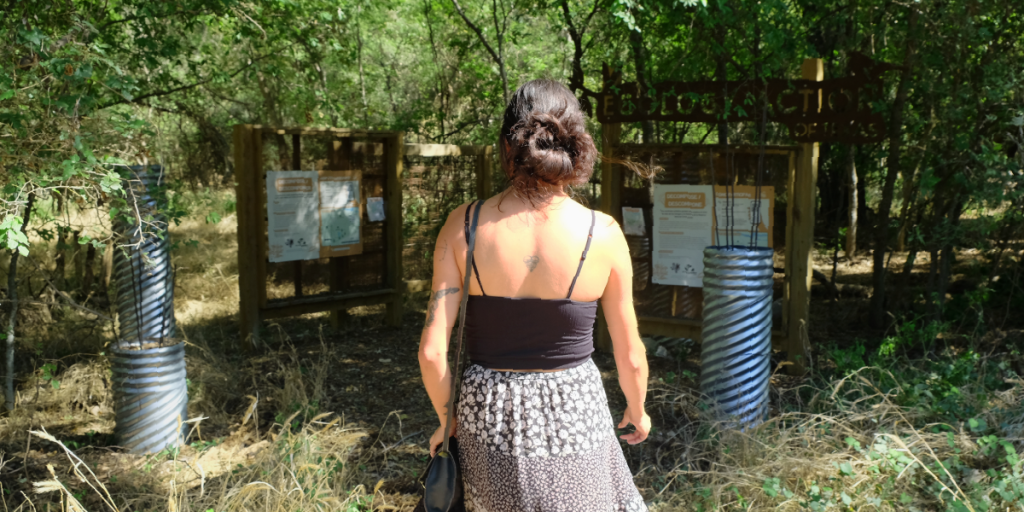 Chiara walks away from the camera into the Ecology Action Circle Acres Preserve.