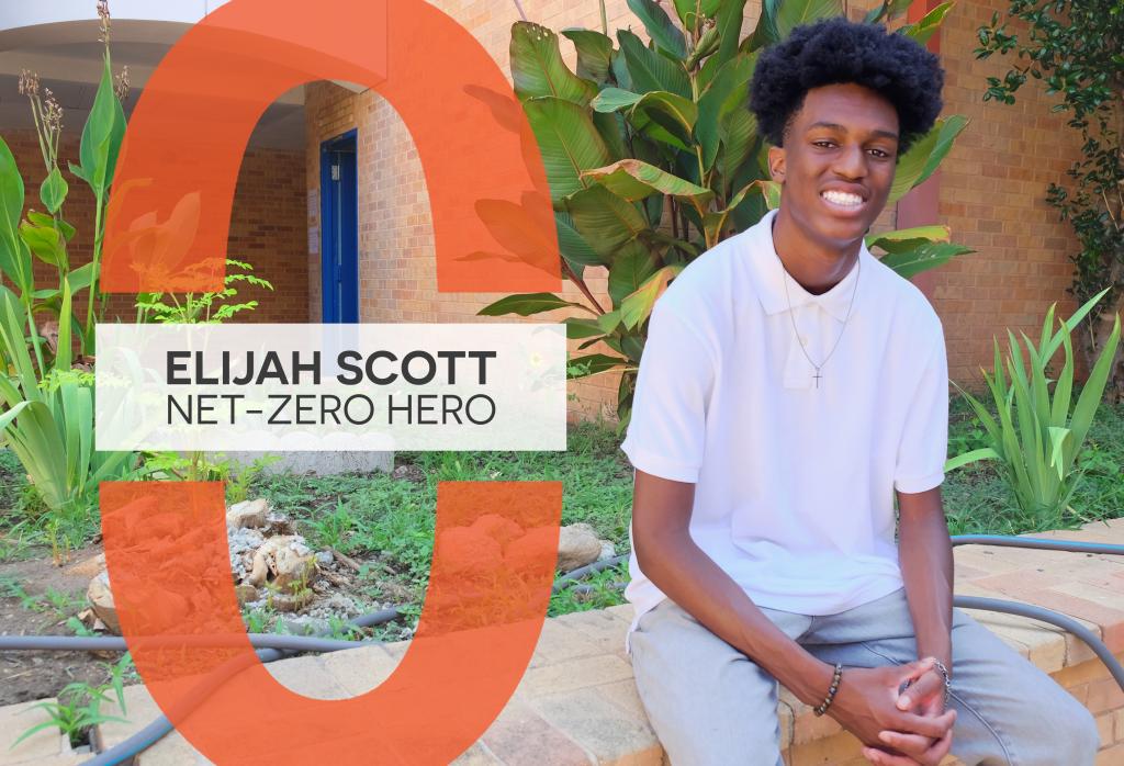 Elijah Scott sits in an outdoor patio at Martin Middle School with foliage all around him.