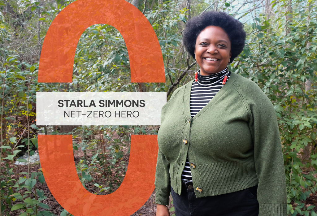 Starla Simmons smiles at the camera. She stands outside in front of greenery.