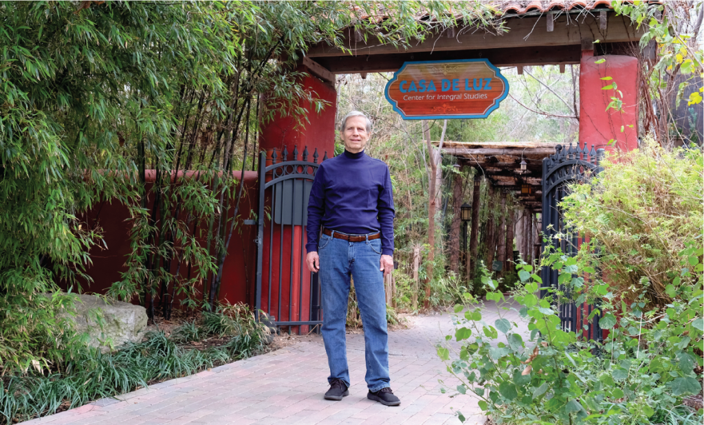 Wayo stands at the entrance of the Casa de Luz Wellness Community.