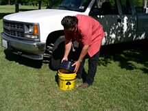 Remove the bucket lid. It is designed to be the drain pan for the oil change.