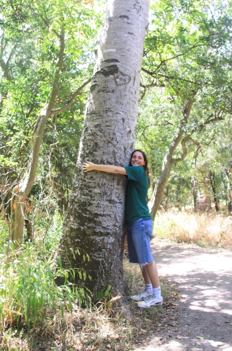 Gabby hugging a tree