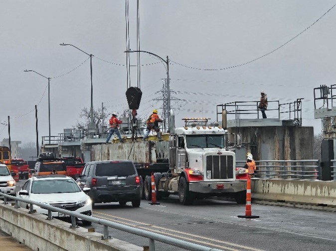 Pictured Below: Austin Water contractors installing one of four stop-logs in the failed gate at Longhorn Dam. 