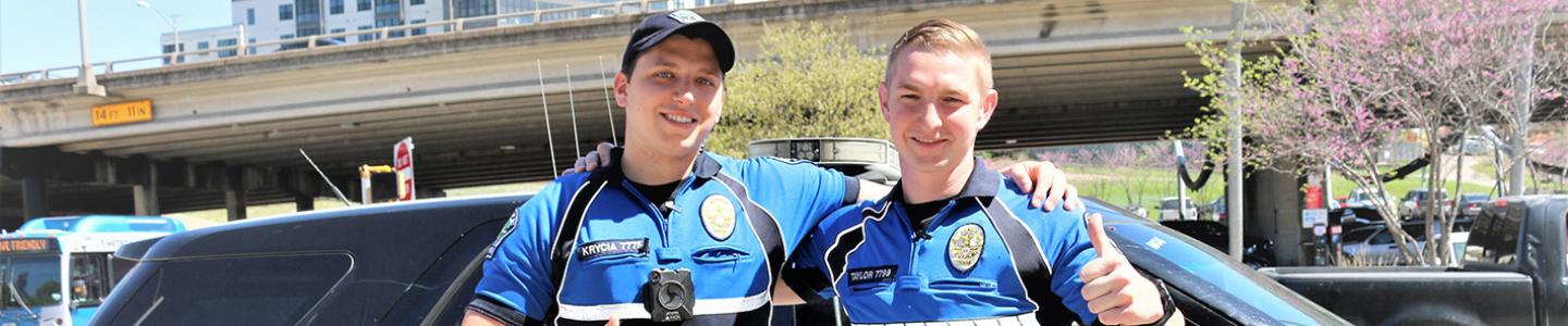 Police officers standing in front of a car