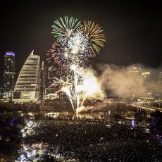 Audtorium Shores at night with downtown Austin lights and fireworks