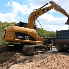 Construction Equipment - Crews work to repair a sanitary sewer overflow. 