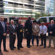 Group of city and county officials stand together for a photo following a press conference about wildfire threat and preparedness.