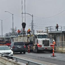 Pictured Below: Austin Water contractors installing one of four stop-logs in the failed gate at Longhorn Dam. 