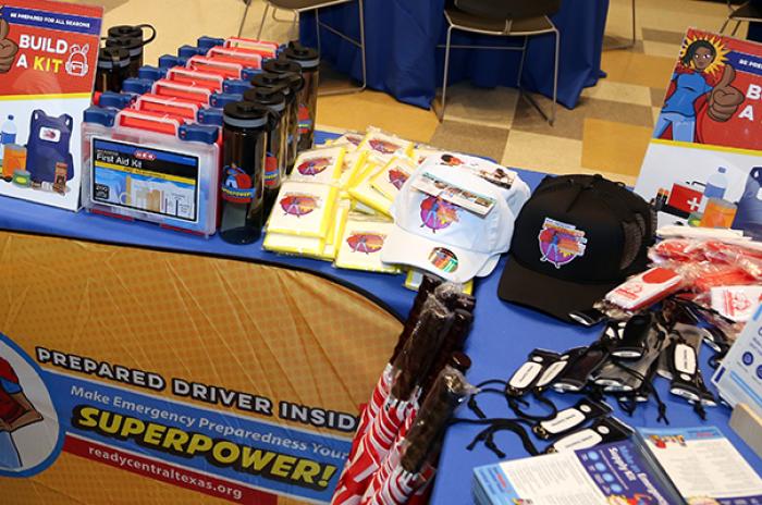 photo displaying a table with emergency supplies and sign reading "Build a Kit". 