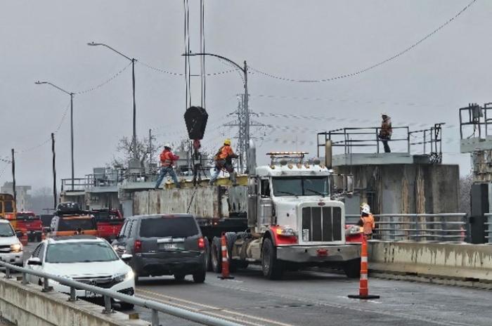 Pictured Below: Austin Water contractors installing one of four stop-logs in the failed gate at Longhorn Dam. 